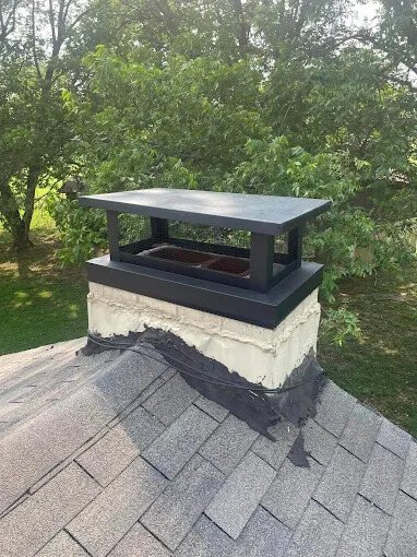 New chimney cap installed on a shingle roof