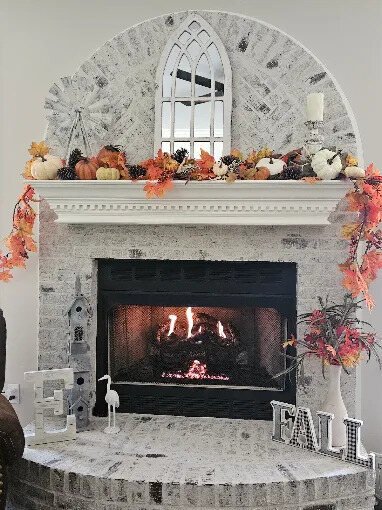 Gas fireplace burning in a finished stone surround