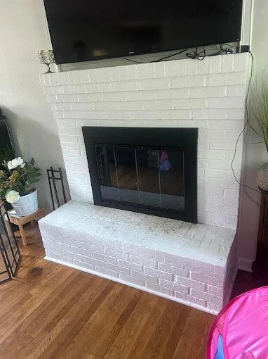 White brick fireplace makeover with mounted TV