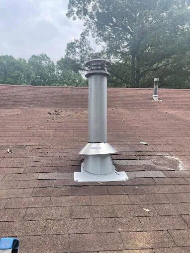 Chimney pipe and flashing on a shingle roof installed by Chimney Works